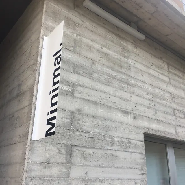 Vertical Wordmark on Concrete Wall, minimal, brutalist, monochrome