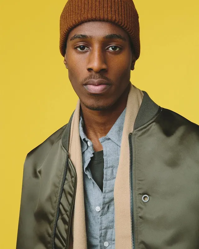Portrait of a Man in a Beanie and Jacket, photographic, minimal, vibrant