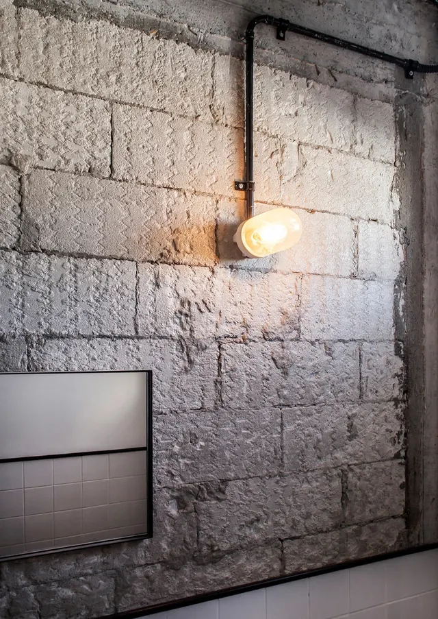 Industrial Interior with Exposed Brick and Conduit Lighting, minimal, brutalist, muted