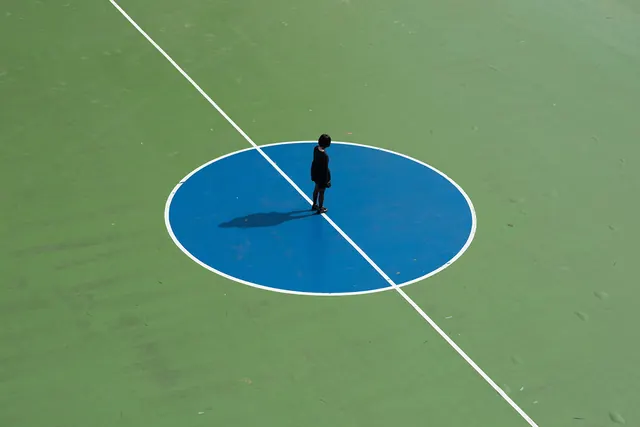 Person Standing on Blue Circle, minimal, geometric, vibrant