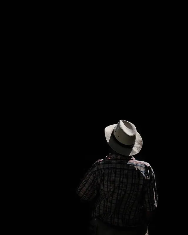 Man in Hat in Dark Space, minimal, photographic, dark