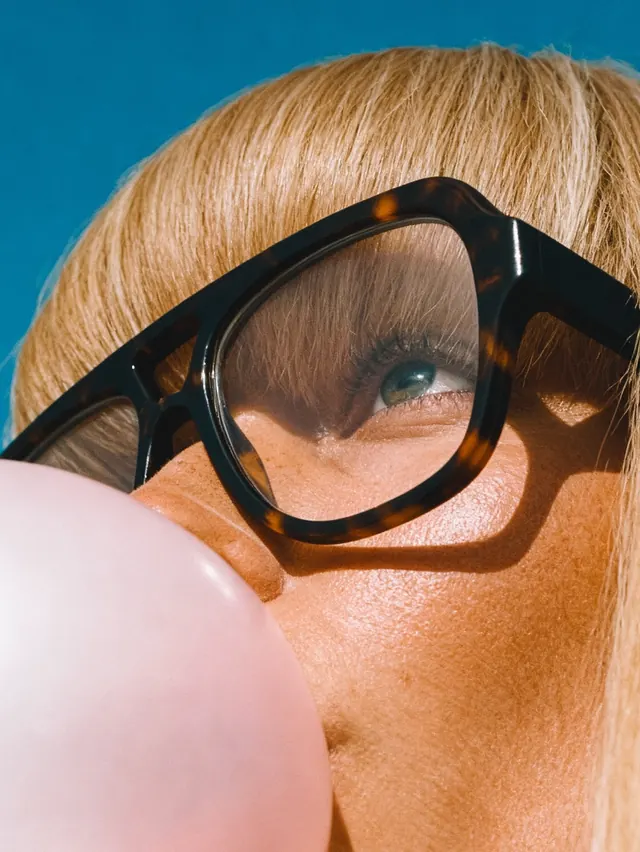 Close-up Portrait with Oversized Glasses, photographic, playful, vibrant