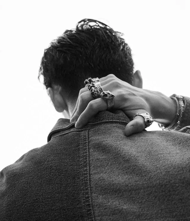 Monochrome rear portrait with stacked silver rings on denim, photographic, monochrome, monochrome