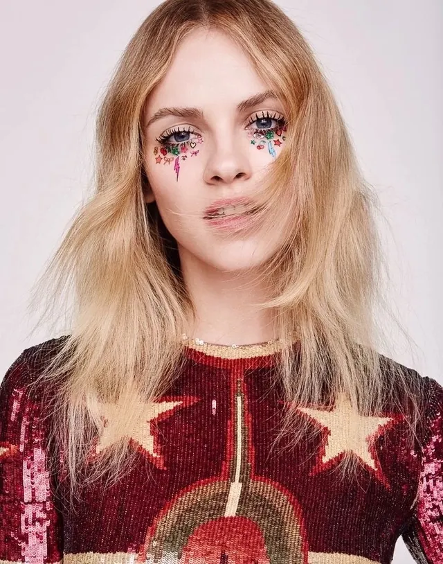 Portrait of a Woman with Face Paint and Patterned Sweater, photographic, playful, vibrant
