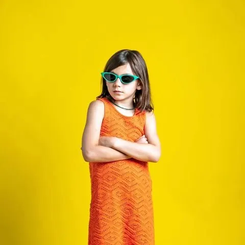 Girl in Sunglasses and Orange Dress, playful, photographic, vibrant
