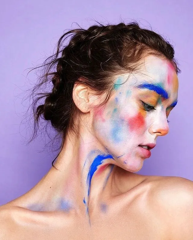 Portrait of a Woman with Blue and Red Face Paint, photographic, maximalist, vibrant