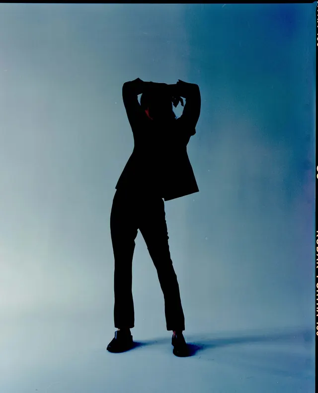 Silhouette of a Person in a Blue Space, minimal, photographic, high-contrast