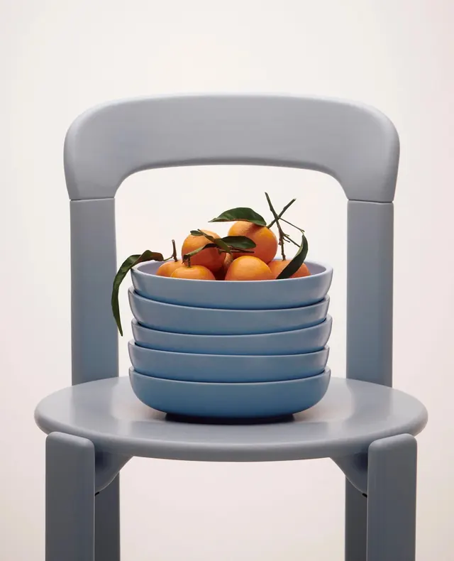 Stacked Blue Bowls with Oranges on a Chair, minimal, 3d-render, light