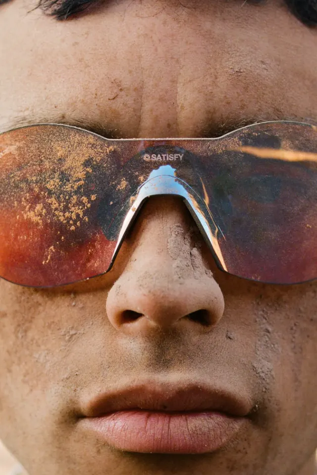Close-up of Person Wearing Reflective Sunglasses, photographic, organic, warm