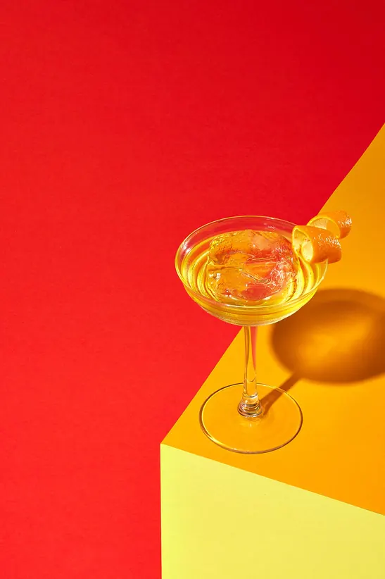 Champagne Glass on Yellow Pedestal, minimal, photographic, vibrant