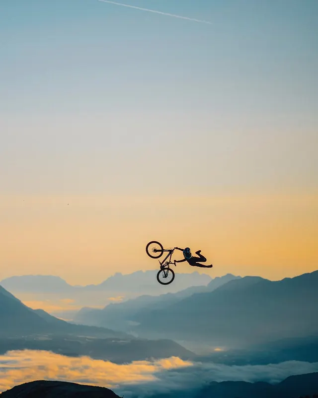 Mountain Biker Silhouette at Sunset, minimal, photographic, warm