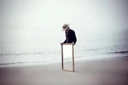 Person Sitting on a Wooden Stool on a Beach, minimal, photographic, monochrome