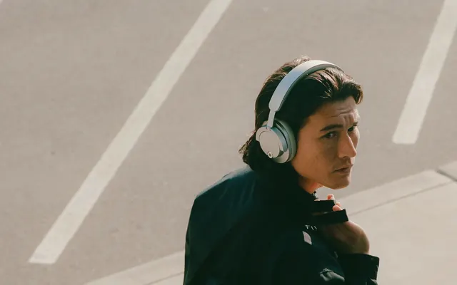 Person Wearing Headphones on Road, photographic, minimal, muted