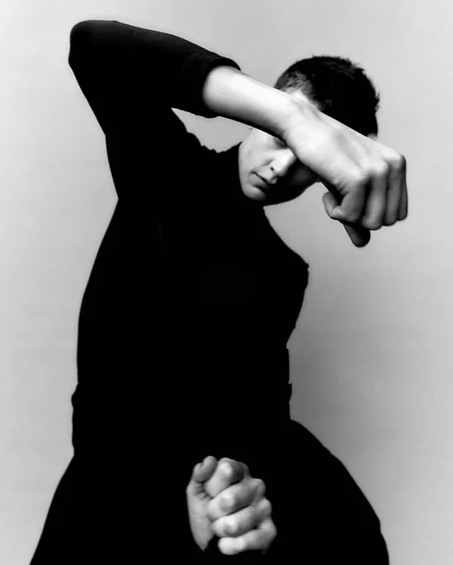 Monochrome Portrait of a Person in a Fist Pose, monochrome, photographic, monochrome