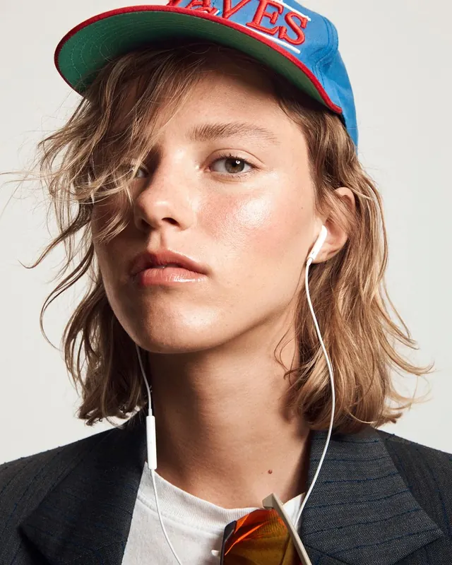 Portrait of a Woman in a Baseball Cap, photographic, organic, vibrant