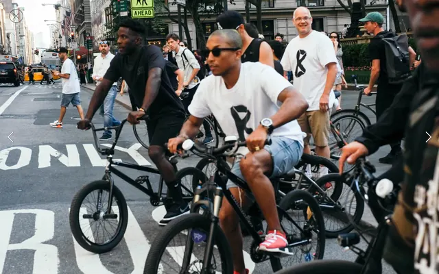 Group of People on Bicycles in City Street, photographic, vibrant