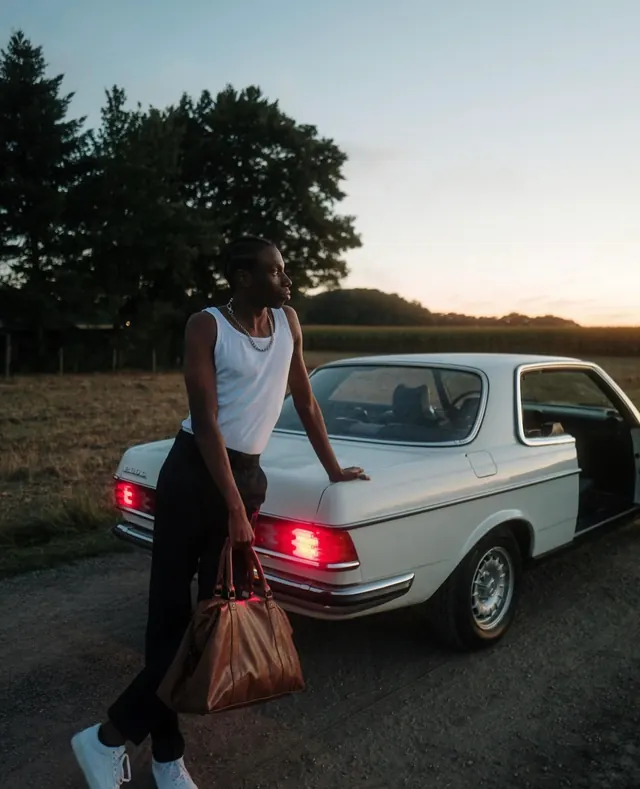 Man with Vintage Car and Shopping Bag, photographic, retro, muted