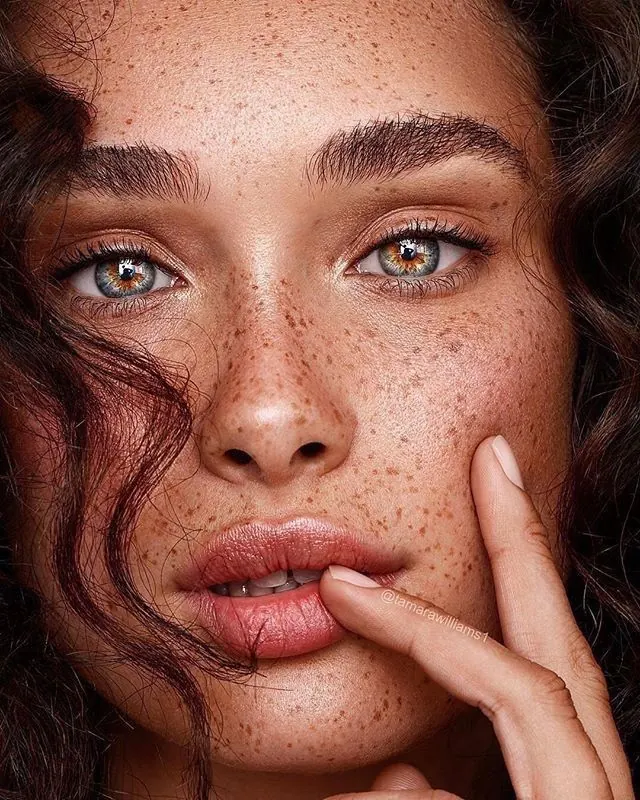 Close-up Portrait of a Woman with Freckles, photographic, organic, warm
