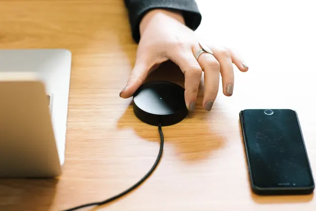 Hand on Computer Mouse and Smartphone, photographic, minimal, warm
