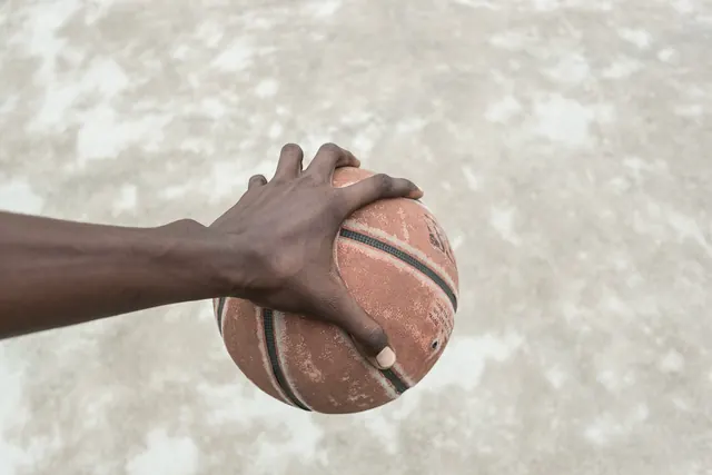 Hand Holding Basketball, photographic, minimal, warm