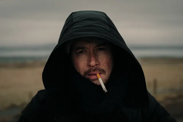 Man in Hoodie with Cigarette, photographic, dark-mode, dark