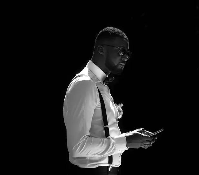 Man in White Shirt Holding Phone, monochrome, photographic, monochrome
