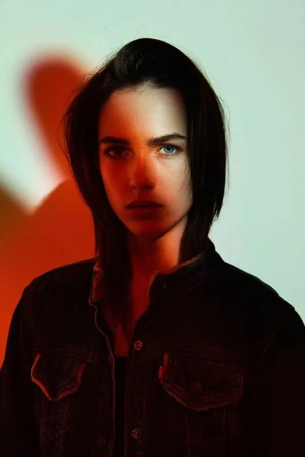 Portrait of a woman in a denim jacket, minimal, photographic, high-contrast