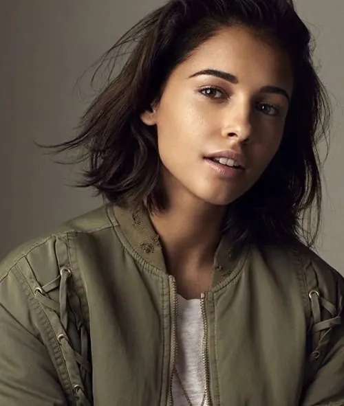 Portrait of a woman in olive jacket, photographic, minimal, muted