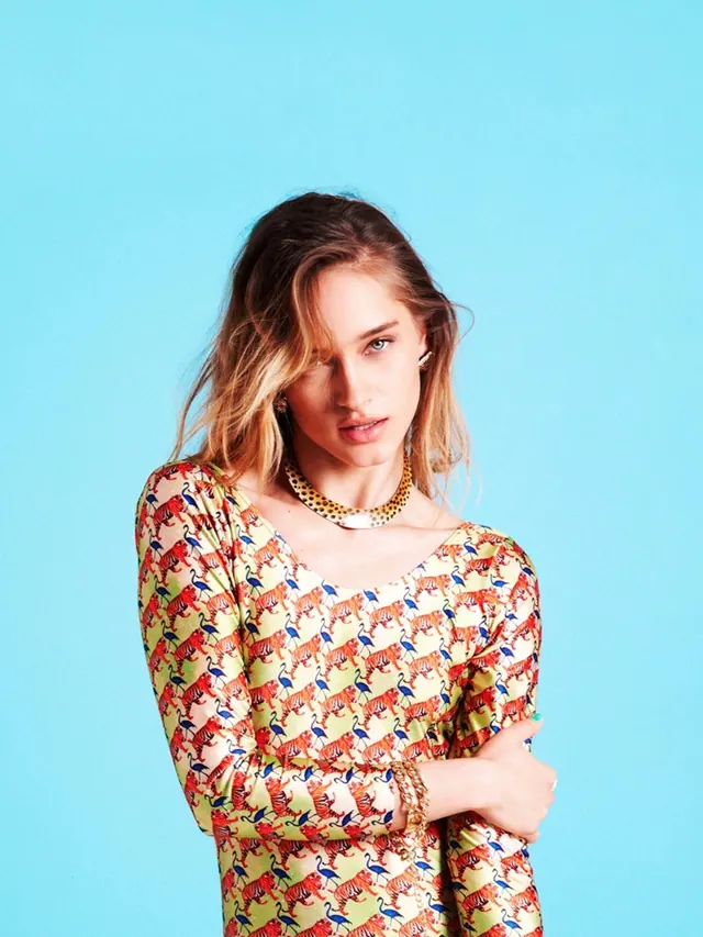 Portrait of a woman in patterned dress, photographic, vibrant