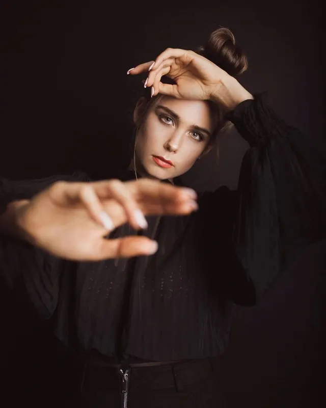 Portrait of a woman in dark attire, minimal, dark-mode, dark