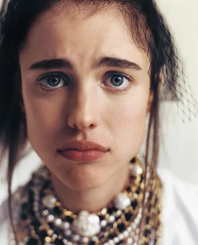 Portrait of a woman with beaded necklace, photographic, organic, muted