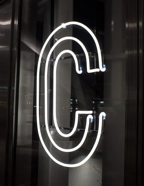 Neon 'C' Signage, minimal, dark-mode, high-contrast