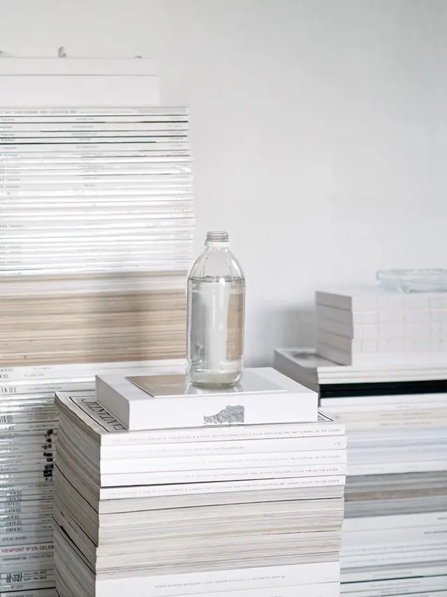 Stacked Paper and Glass Bottle, minimal, light-mode, light