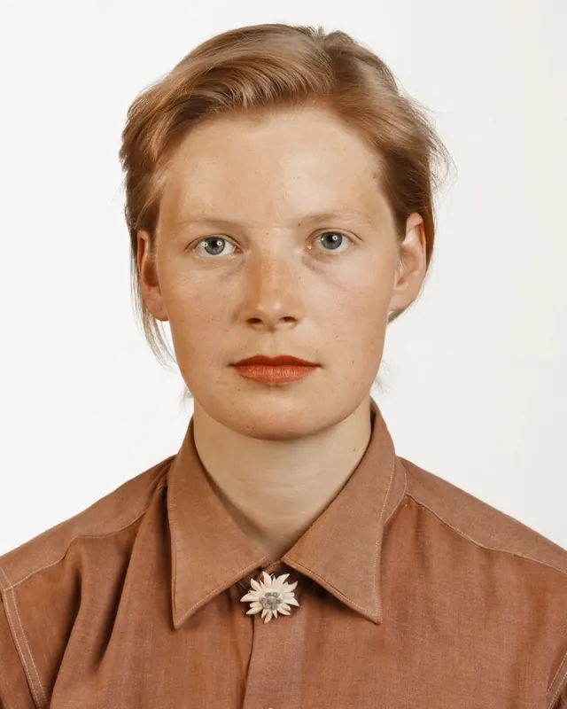 Portrait of a woman in a collared shirt, minimal, photographic, warm