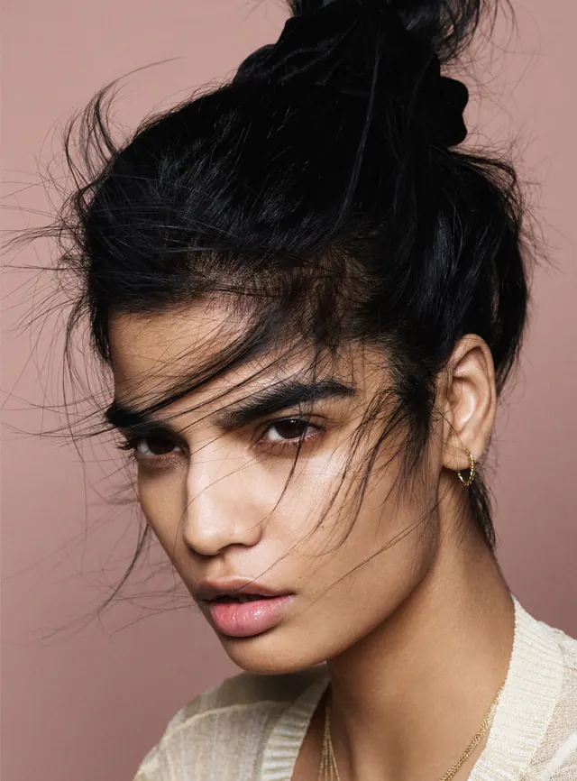 Portrait of a woman with wet-look hair, photographic, minimal, muted