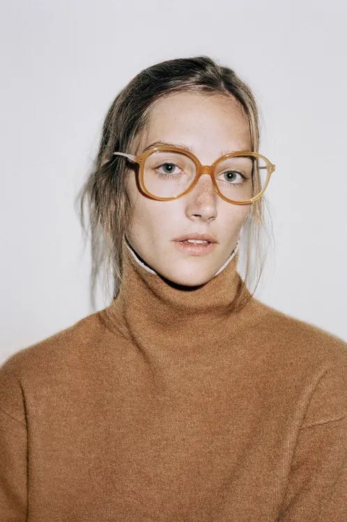 Portrait of a woman in a turtleneck, minimal, photographic, warm