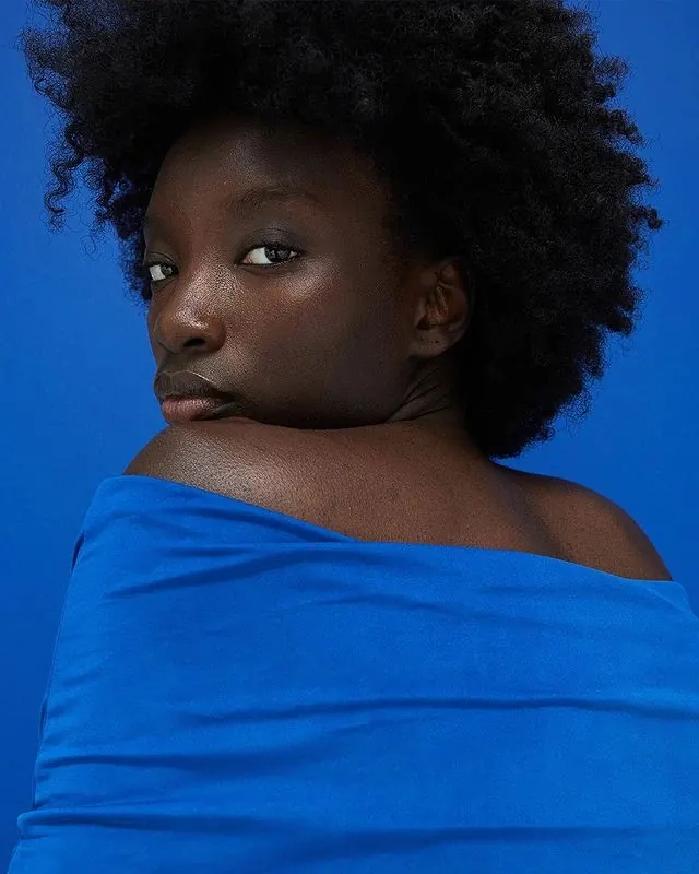 Portrait of a Woman in Blue, photographic, minimal, vibrant