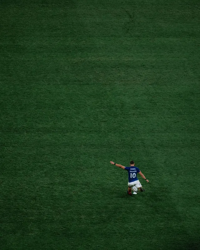 Soccer Player on Grass Field, minimal, photographic, dark