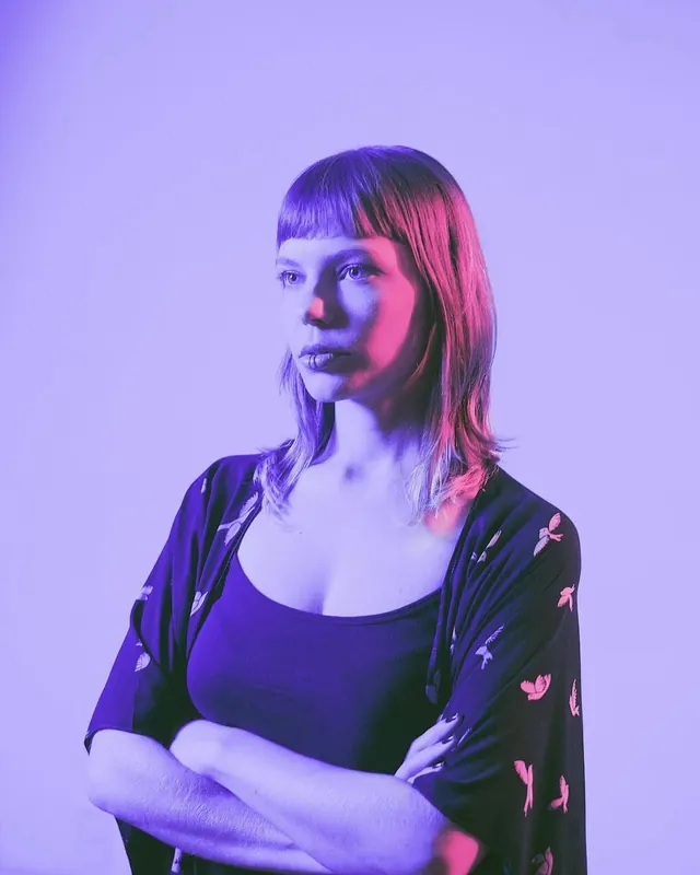 Portrait of a woman in neon lighting, photographic, vibrant