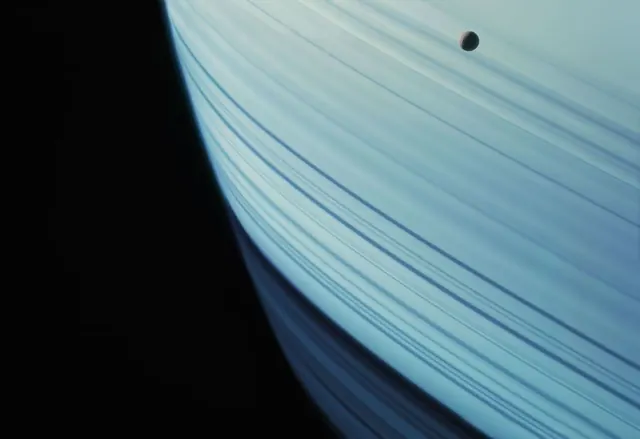 Planet rings with orbiting moon, minimal, abstract, light