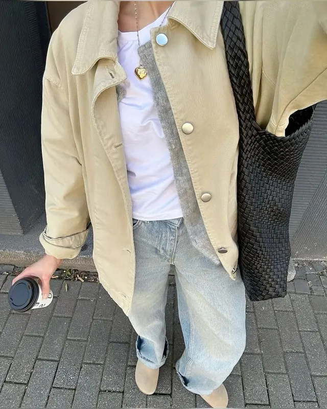 Oversized button-up shirt over striped tee and vintage denim, photographic, minimal, light