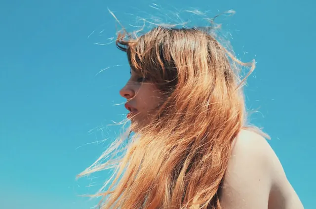 Profile Portrait of Woman with Red Hair, photographic, minimal, vibrant