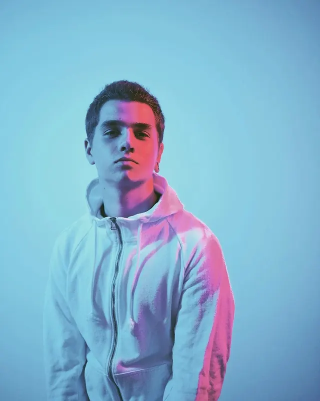 Portrait of a man in a white hoodie, photographic, vibrant