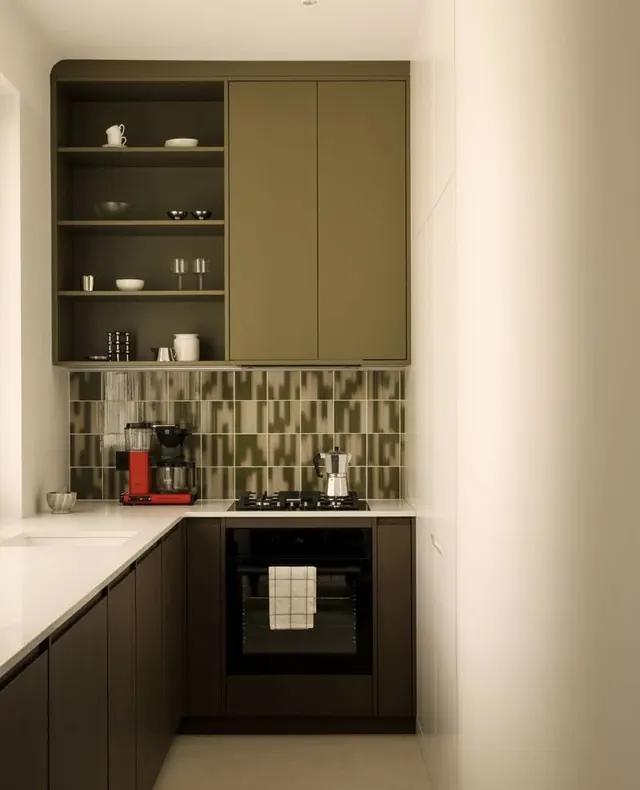 Olive kitchen with stacked shelving and geometric backsplash, minimal, corporate-clean, dark