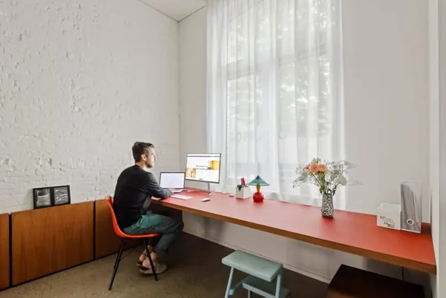 Minimalist workspace with coral desk, minimal, photographic, warm