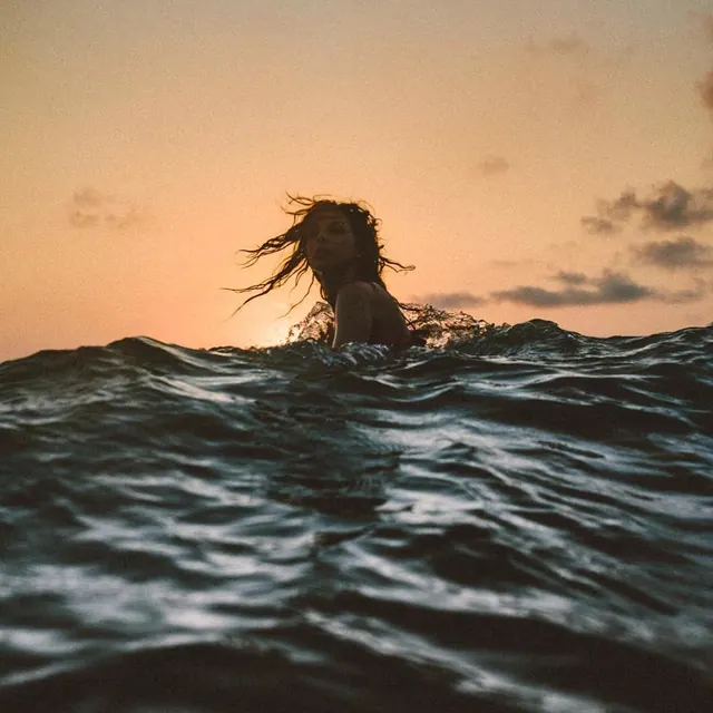 Person in Water at Sunset, photographic, organic, warm