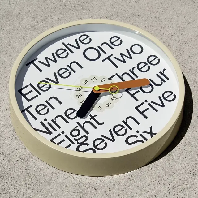 Minimal ceramic clock face with concentric text, minimal, geometric, light