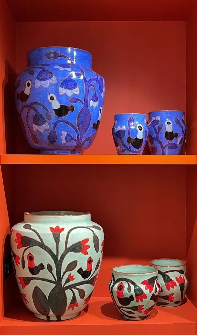 Blue and white ceramic vessels with botanical motifs, illustrated, vibrant