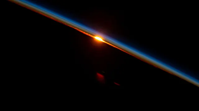Earth limb atmospheric glow space view, photographic, dark