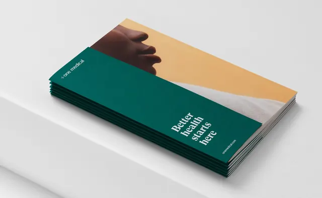 Stacked healthcare brochures with warm and teal color blocking, minimal, corporate-clean, dark